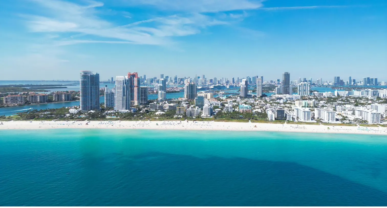 Aerial view of South Beach, Miami, with turquoise water and the city skyline